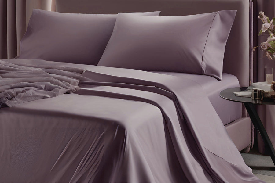 Plum luxury organic bed sheets and pillowscases on a bed with a neutral background by House of March
