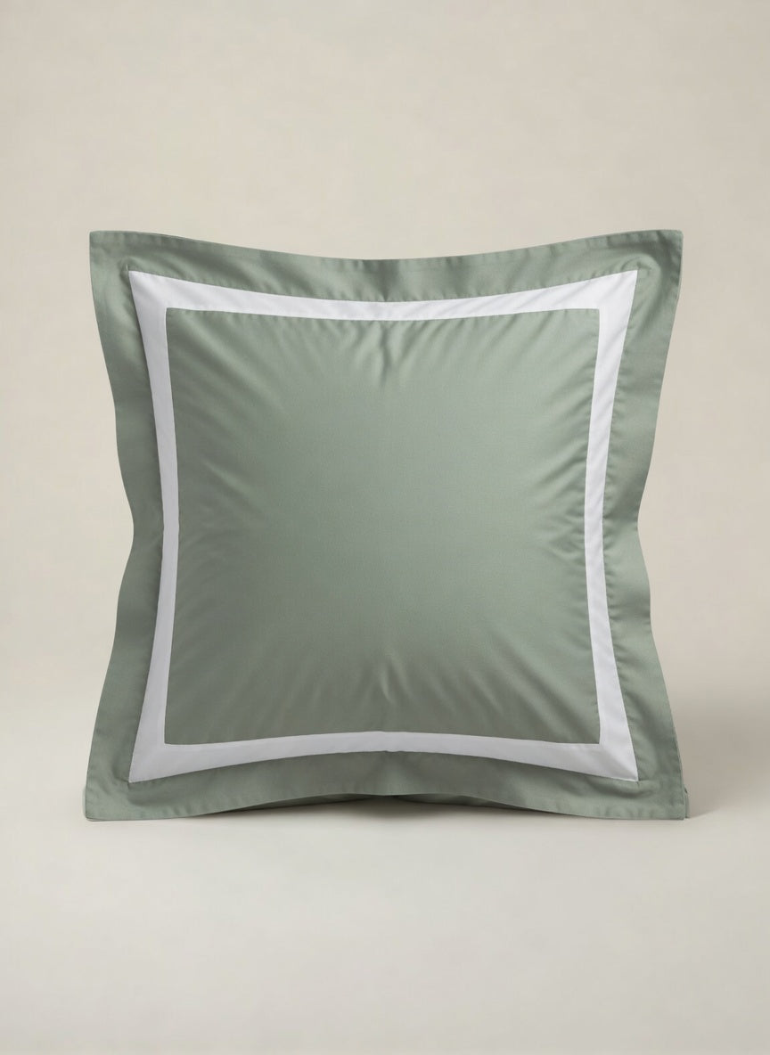 Bedroom with a wooden bed frame and sage green bedding. House of march banded bedding.