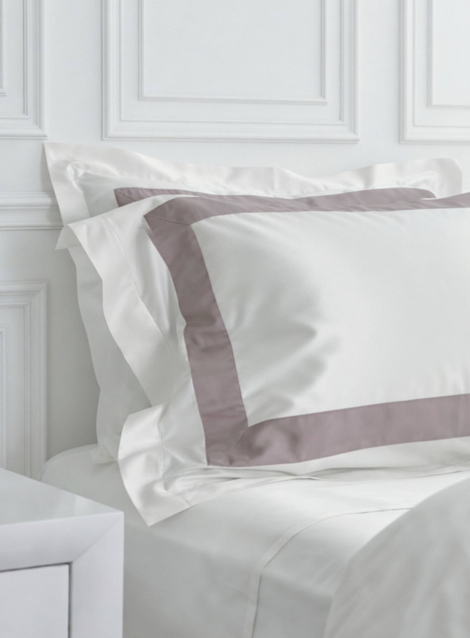 Banded bedding from House of march in plum band and white organic cotton. white wall