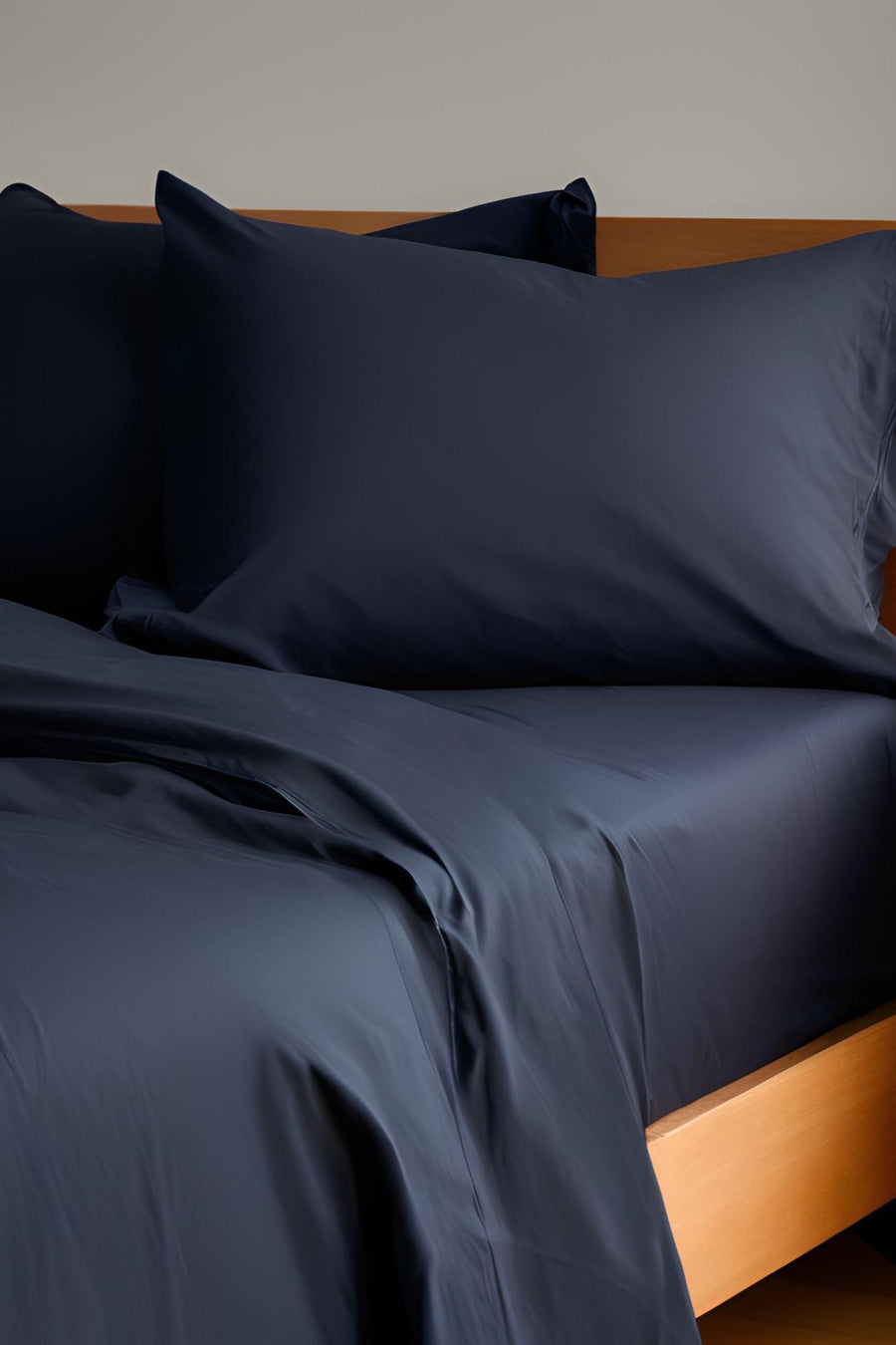 House of March Darkest Blue organic cotton hemmed pillowcase pair on bed