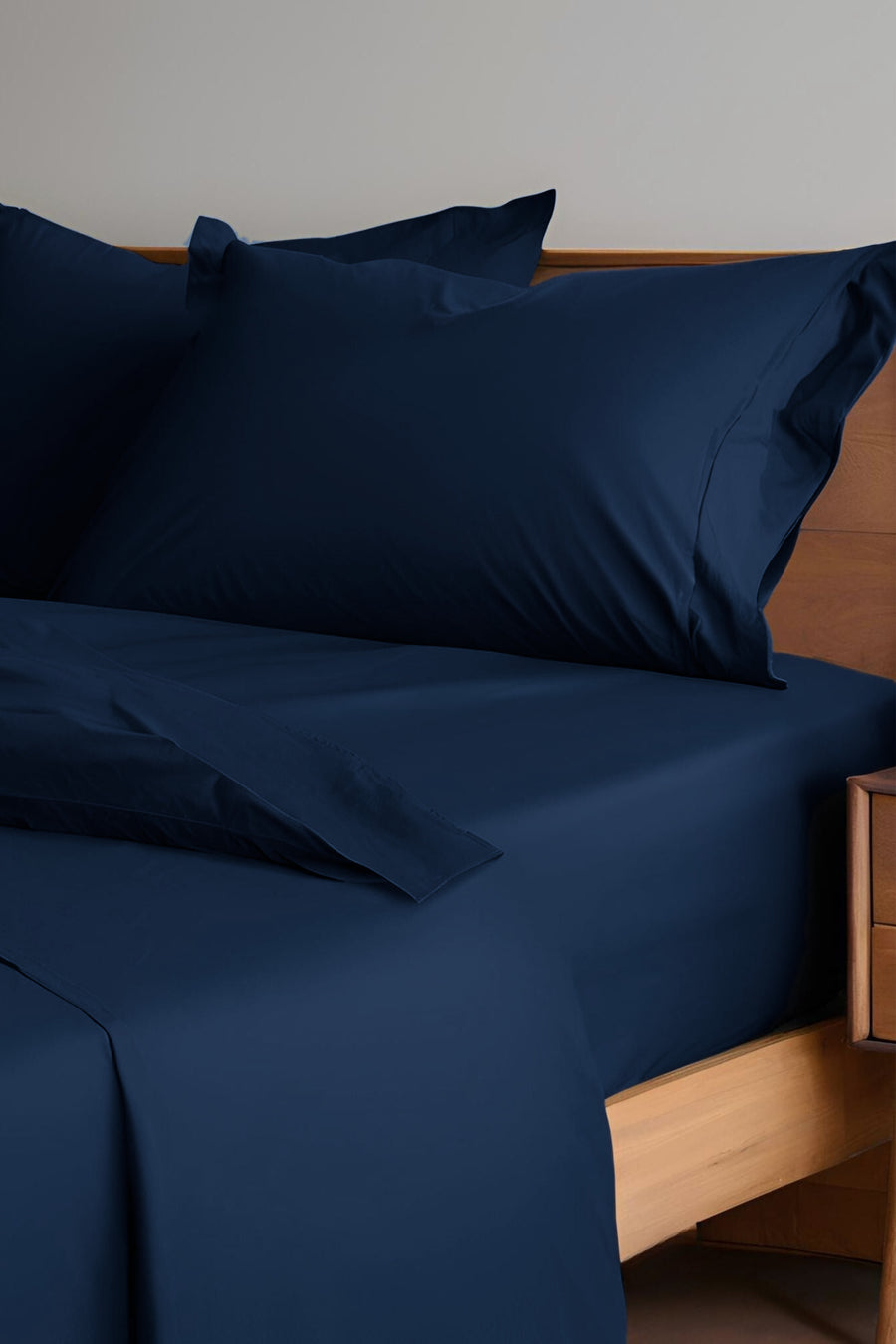 House of March Ink Blue organic cotton a bed made with ink blue sheets and pillowcases