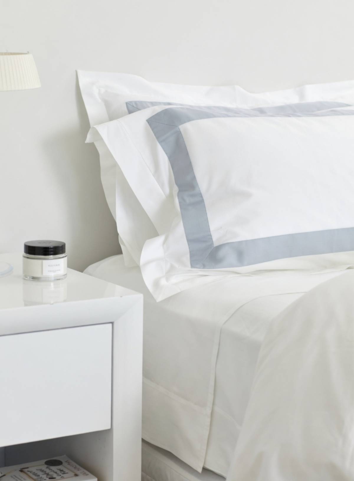 House of march flat sheet in signature range on a bed